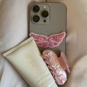 Angel Hold Plushie Sticker on phone with sweetheart clip and angel hold styling cream