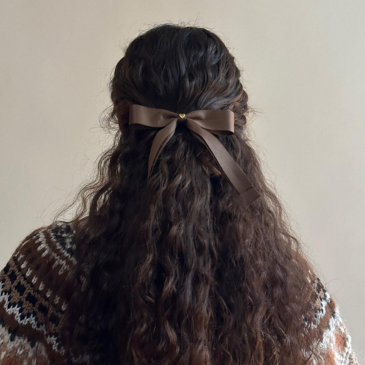Model wearing Bow Barrette in Toasted Sugar in hair.