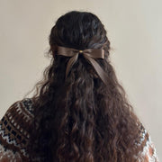 Model wearing Bow Barrette in Toasted Sugar in hair.