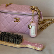 Mini Angelstick + Keychain attached to bag next to Mini Boar Brush in Pink Sugar