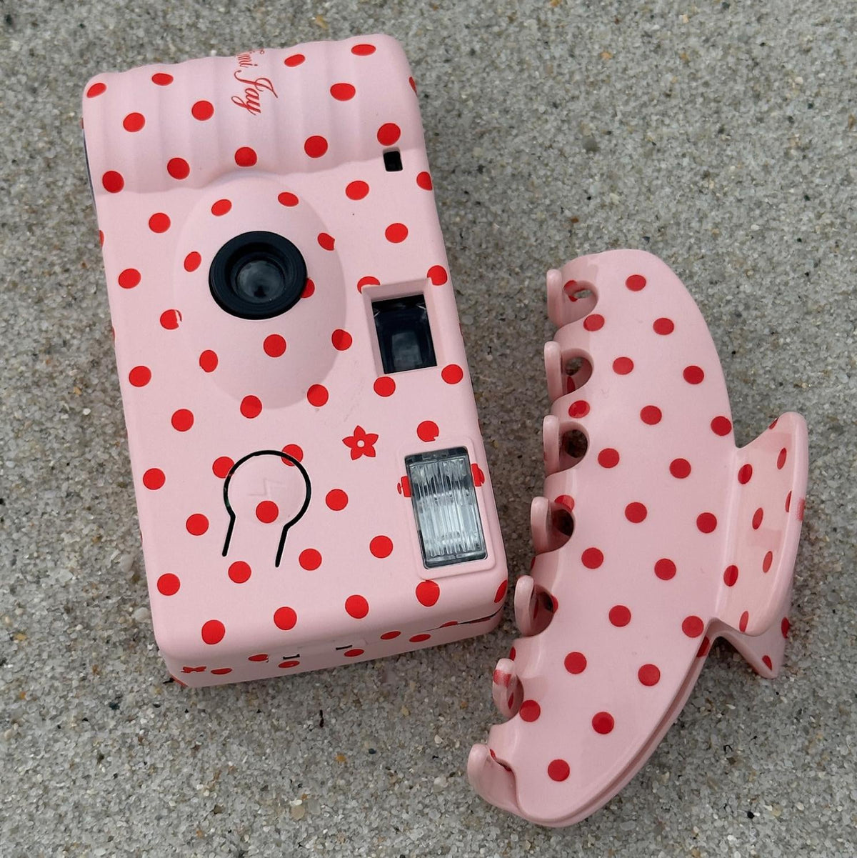 Lychee Baby Disposable Camera next to big effing clip on sand