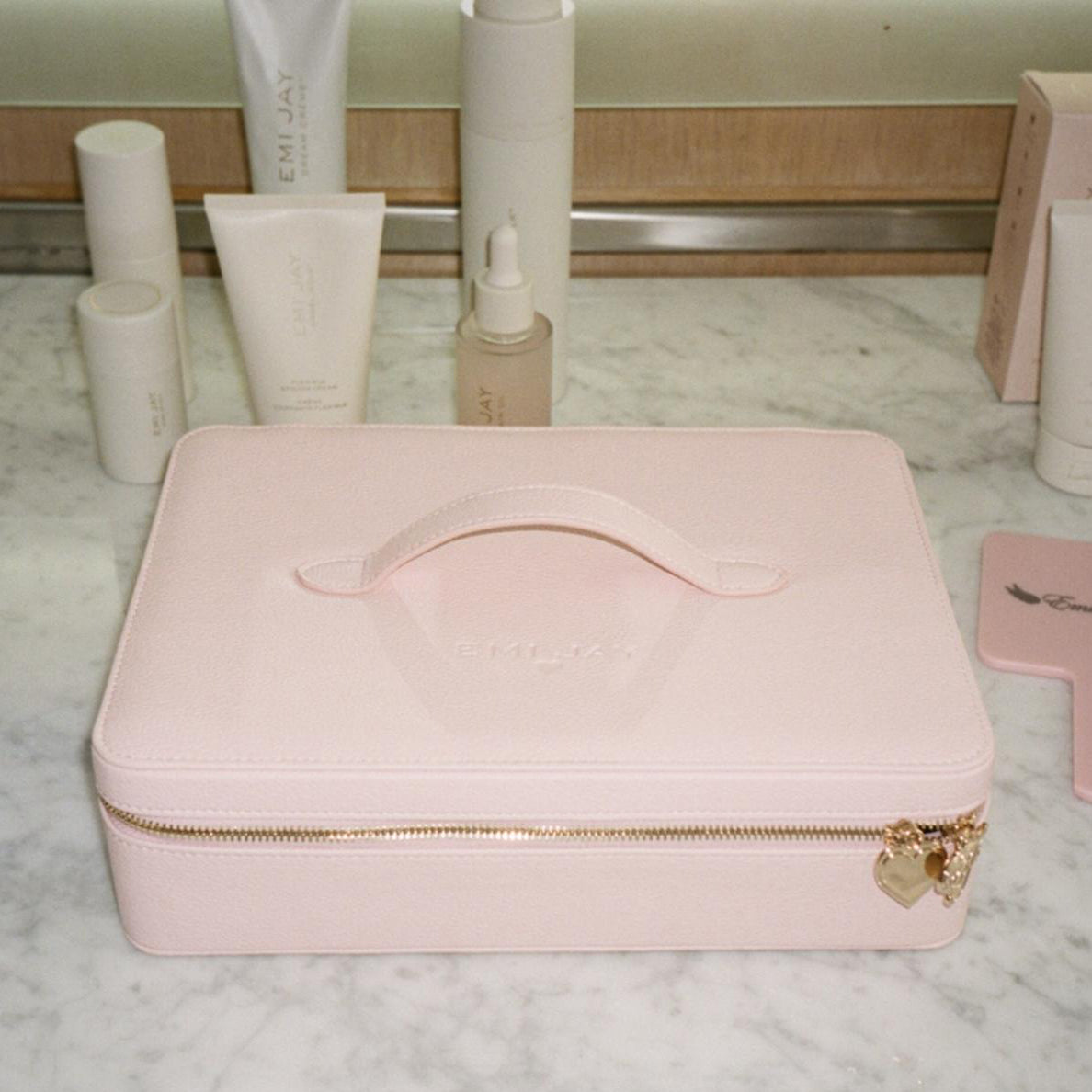 On The Way Vanity Case on marble counter with assorted emi jay hair care and mirror