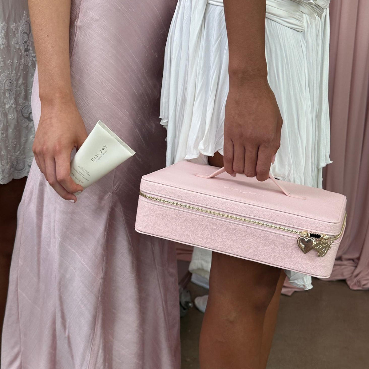 closeup of models holding Angel Hold and On The Way Vanity Case