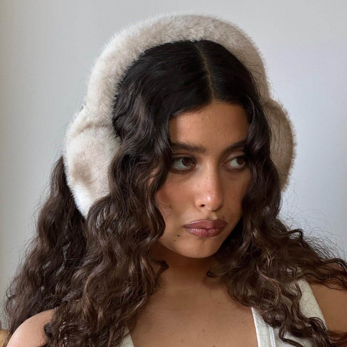 Closeup of model wearing Sugar Muffs in Après Ski.