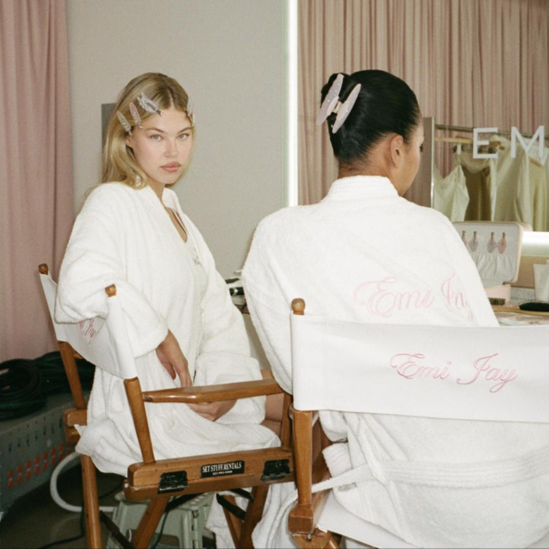 models in robes sitting in emi jay chairs wearing hair clips