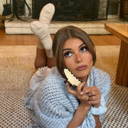 olivia jade holding Big Effing Clip in Milk and Cookies while wearing bedtime angel socks