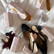assorted blind boxes and sweetheart clips on bed with shoes and keychains