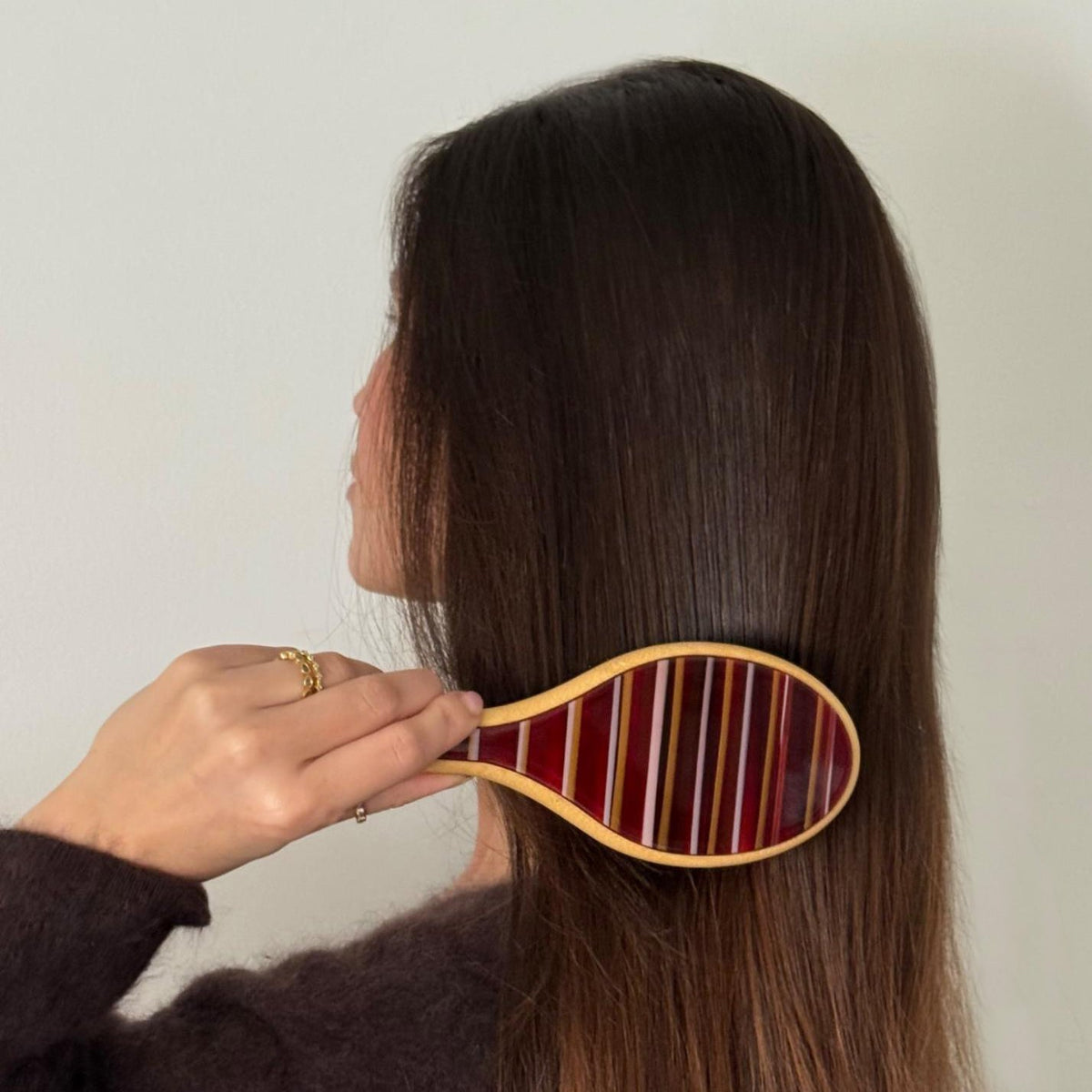 model brushing hair with Flat Brush in Nightcap