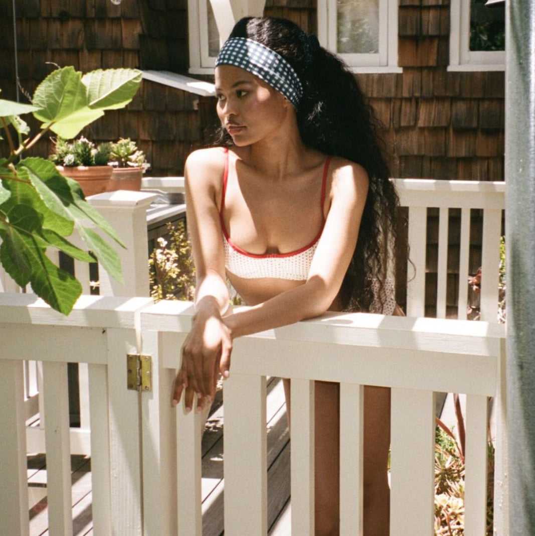 model leaning over door while wearing Infinity Headband in Navy Gingham in hair