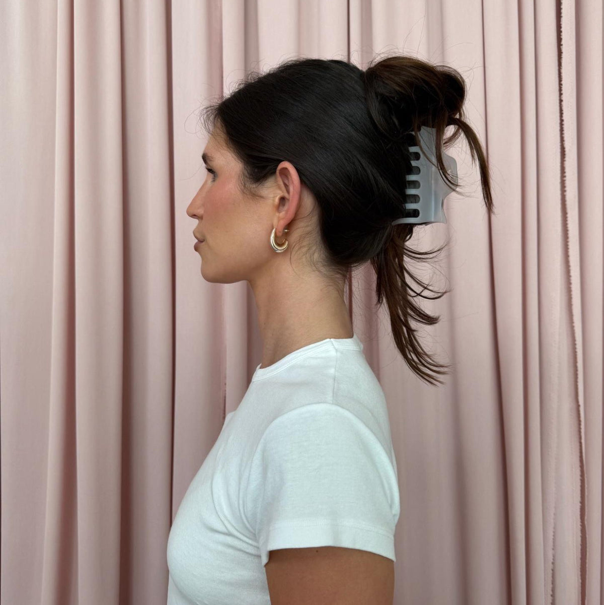 model in front of pink curtain wearing Heartbreaker Clip in Grey Smoke in hair