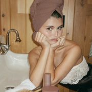 olivia jade wearing Heavenly Hair Towel in Toasted Sugar with assorted hair care and accessories on counter