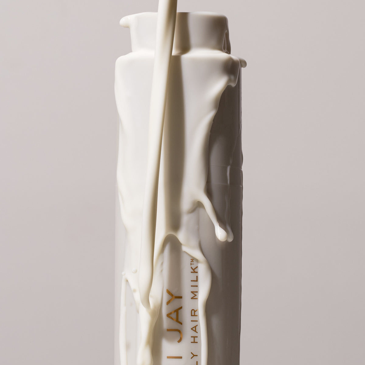 heavenly hair milk bottle with top up and being covered with milk