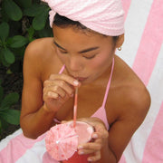 model drinking out of straw while wearing Heavenly Hair Towel in Lychee Baby