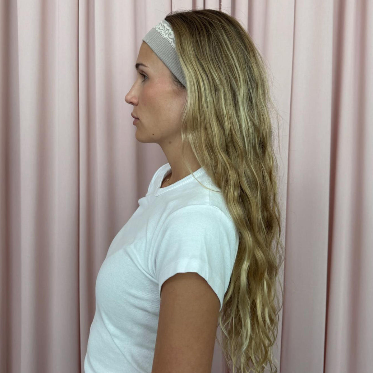 model standing in front of pink curtain wearing Infinity Headband in Grey Smoke in hair