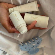 model holding emi jay hair care products next to Lil Effing Clip in Blue Petal Eyelet