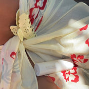 Lil Effing Clip in Citrine Petal Eyelet clipped to fabric next to aura mist in angel wings
