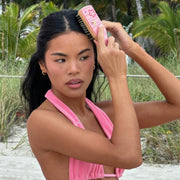 model brushing hair with Mini Boar Bristle Brush in Lychee Baby