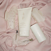 assorted emi jay hair care and accessories on pink fabric