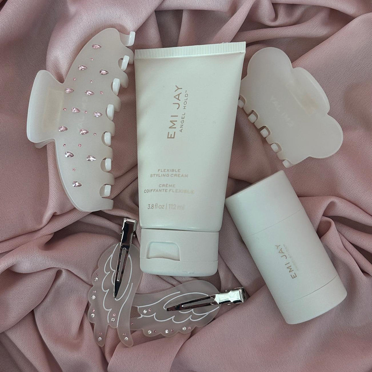 emi jay hair care and clips on pink fabric