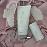emi jay hair care and clips on pink fabric