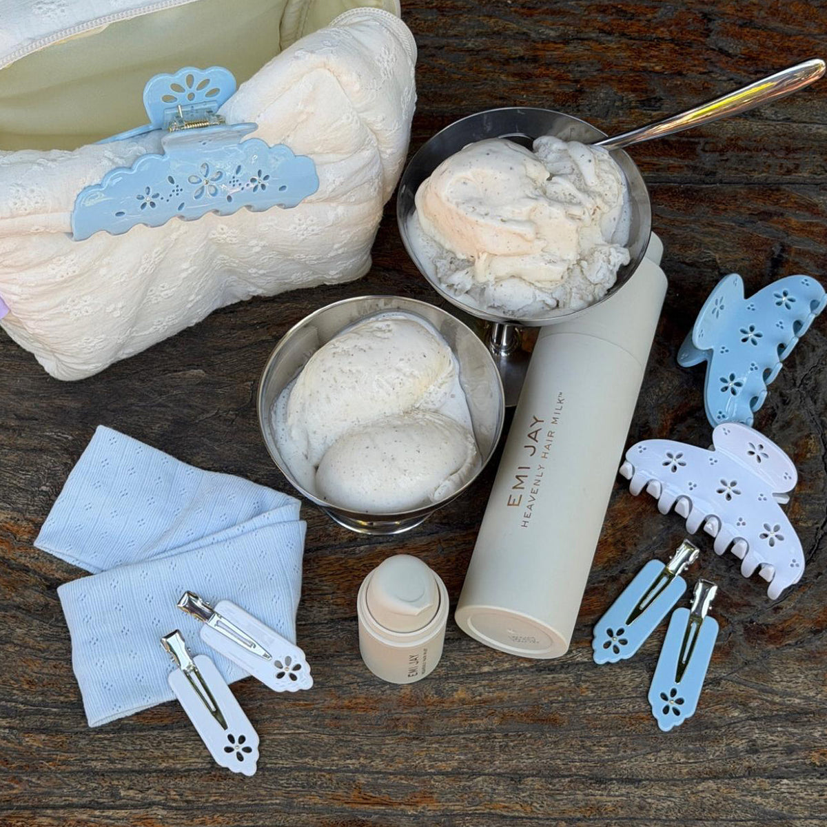 Popstar Clips in Blue Mist Eyelet on table with ice cream in dish, heavenly hair milk, pouch, and hair accessories