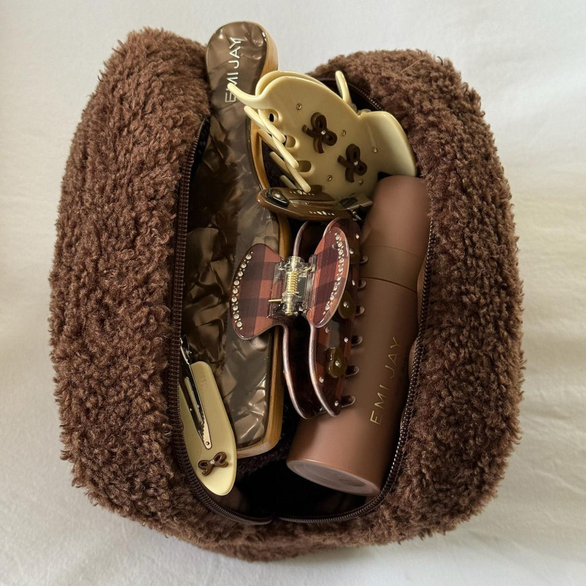 Assorted Emi Jay hair care, accessories, and styling tools in Teddy Pouch in Toasted.