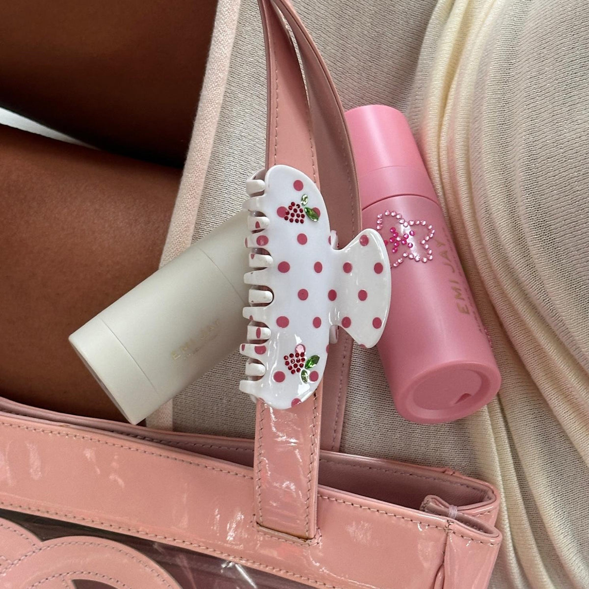 Sweetheart Clip in Coconut Berry Dot clipped to bag strap next to emi jay hair care
