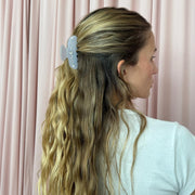 model standing in front of pink curtain with Sweetheart Clip in Lilac Sky in hair